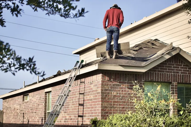 Professional roofer working on a residential roof in Patterson